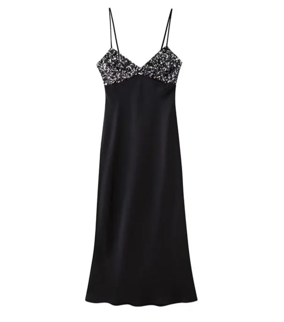 Black dress with sequins on the chest in satin