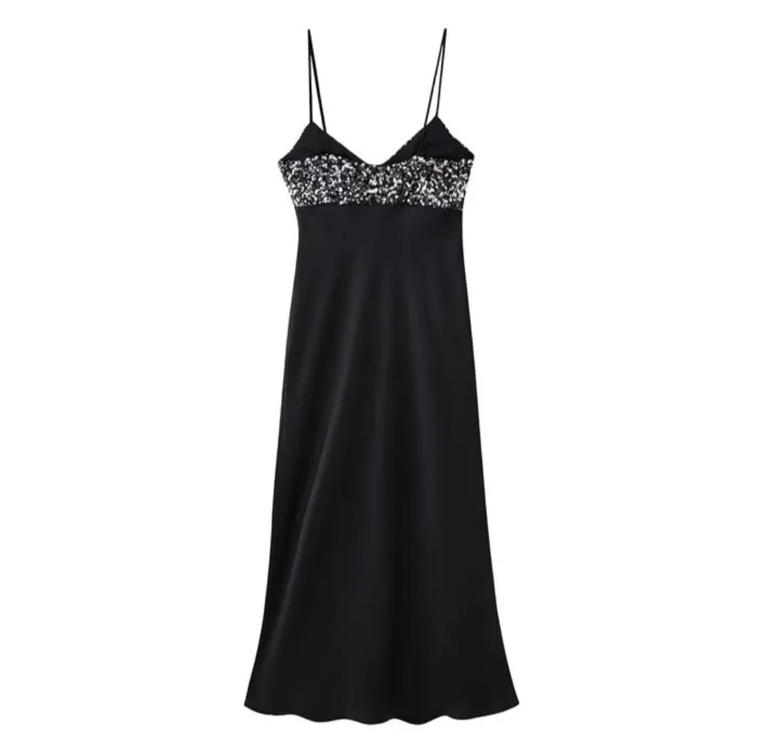 Black dress with sequins on the chest in satin